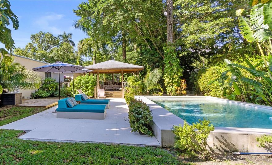 Unique resort style 3BD/3BA pool home in trending village of El portal with an oversized 10,700 sqft lot. Recently renovated form top to bottom it offers: open concept living/dinning and kitchen with great island and wine cooler, 3 bedrooms with wooden vaulted ceilings and fans, very ample bathrooms, walking closets and tons of storage space, aluminum roof, impact windows, wood floors, solar panels, water purifying system for the whole house and bathed in beautiful natural light. This is a dream house to entertain. The outdoor space, a true oasis, offers a state of the art oversized 760 sqft crafted pergola with vaulted ceilings and fans, pool, outdoor shower with hot/cold water, and a fabulous mature lush garden. Prepare to fall in love with this home!