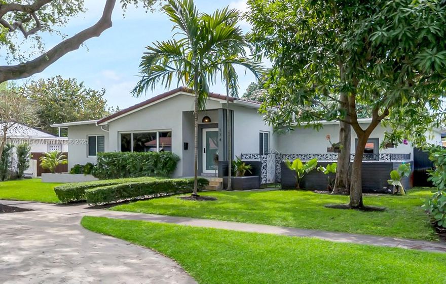 Seductively sleek, bold and tropical, yet impressively modern. Welcome to Casa Amazonica! Awaken your senses at this MUST SEE three bed-two bath updated designer home. Enter into open flow living, plus gourmet island eat-in open kitchen, leading to a light and bright Florida room den with dining, opening to the rear lush gardens, complete with a grand entertainment and dining covered pergola, a putting green, and so much room to relax and play. Sweet dreams await in three comfortable bedrooms, including a walk-in closet principal ensuite. Great features: modern magazine-ready design throughout; impactful artistic Amazon-inspired wall coverings; impact windows-doors; porcelain plank flooring; JennAir appliances; and room for a pool. All in a fantastic Miami Shores non-flood zone location!