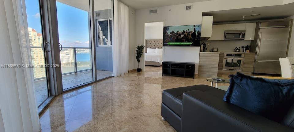 Live in this sophisticated condo in Miami's most desirable neighborhood. Spectacular 2br/2bath/half-bath with marble floors. Breathtaking bay view from master bedroom and balcony and skyline view of beautiful Brickell. Top of the line kitchen and bathrooms. Amazing amenities include rooftop pool, theater, state-of-the-art gym, steam and sauna room, clubhouse, a 50-foot lap pool with jacuzzi and cabanas and an automatic robotic parking system. Unit comes with 2-parking spaces, this find is very rare at Brickell House! Management office on site. Shops and dining near. Monthly and seasonal rentals allowed. Easy to show. Call listing agent