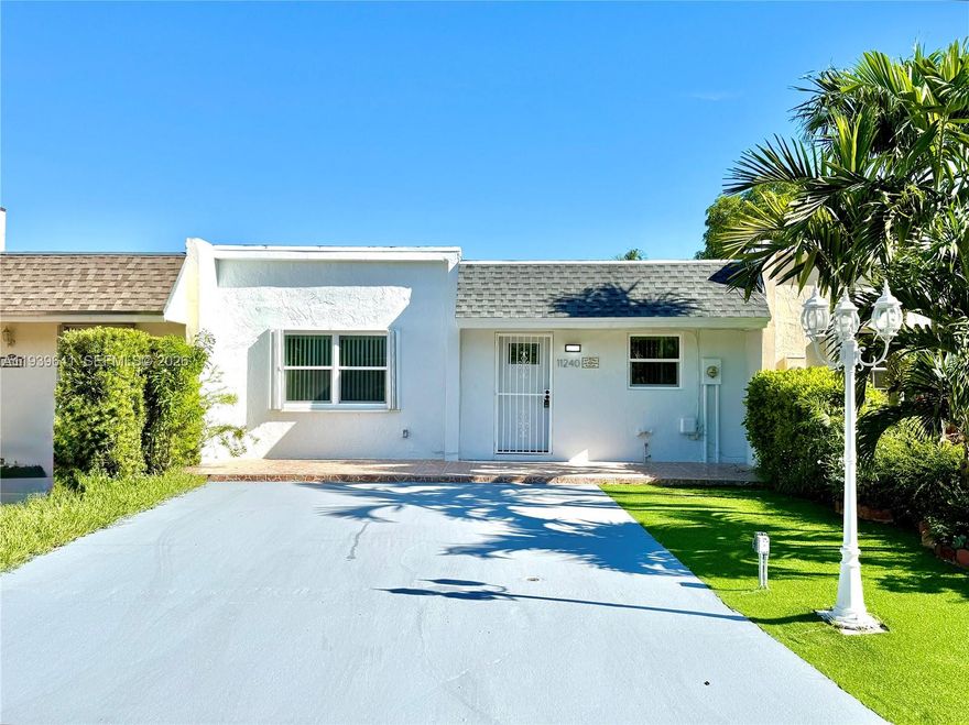 New Roof 2025 & Impact Windows Throughout! Beautifully updated 2-bedroom, 2-bath villa with an extremely low HOA and a large, fully enclosed private backyard, offering rare privacy and flexibility. Commercial vehicles are allowed, and the spacious driveway provides added convenience. This move-in-ready home features porcelain tile throughout, spacious bedrooms, and a bright, open layout. The modern kitchen is designed for both style and function, with white cabinetry, a large center island, Calacatta quartz countertops, and new stainless steel appliances. Both bathrooms include walk-in showers, and the home is complete with a new washer and dryer. Ideally located near shopping, dining, and major roadways, this villa combines comfort, upgrades, and versatility