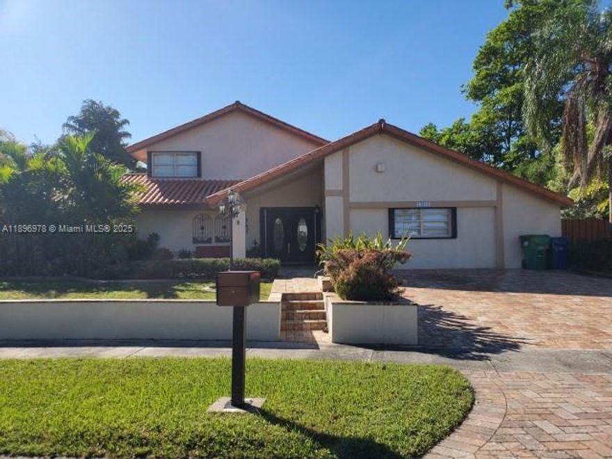 Well-maintained 5/3.5-bath home sits on 12,500 sq ft corner lot. 2 master bedrooms w/full baths on the1st floor. 3/1 upstairs ideal for children/guests. Interior highlights include a formal living room w/a cozy conversation pit, large family room, formal dining & a daily dining area adjacent to an open kitchen w/a brand-new refrigerator. Laundry room includes a second refrigerator & built-in cabinetry. Outdoor features include a covered terrace perfect for entertaining, avocado tree, gated side yard for pets, a custom storage shed w/flooring & concrete slab w/double gate access for boat/RV parking. 2 newer AC units, barrel tile roof, accordion shutters, a 5" concrete slab on the second floor for sound insulation. This property offers space, comfort, & flexibility—ready for a new family.