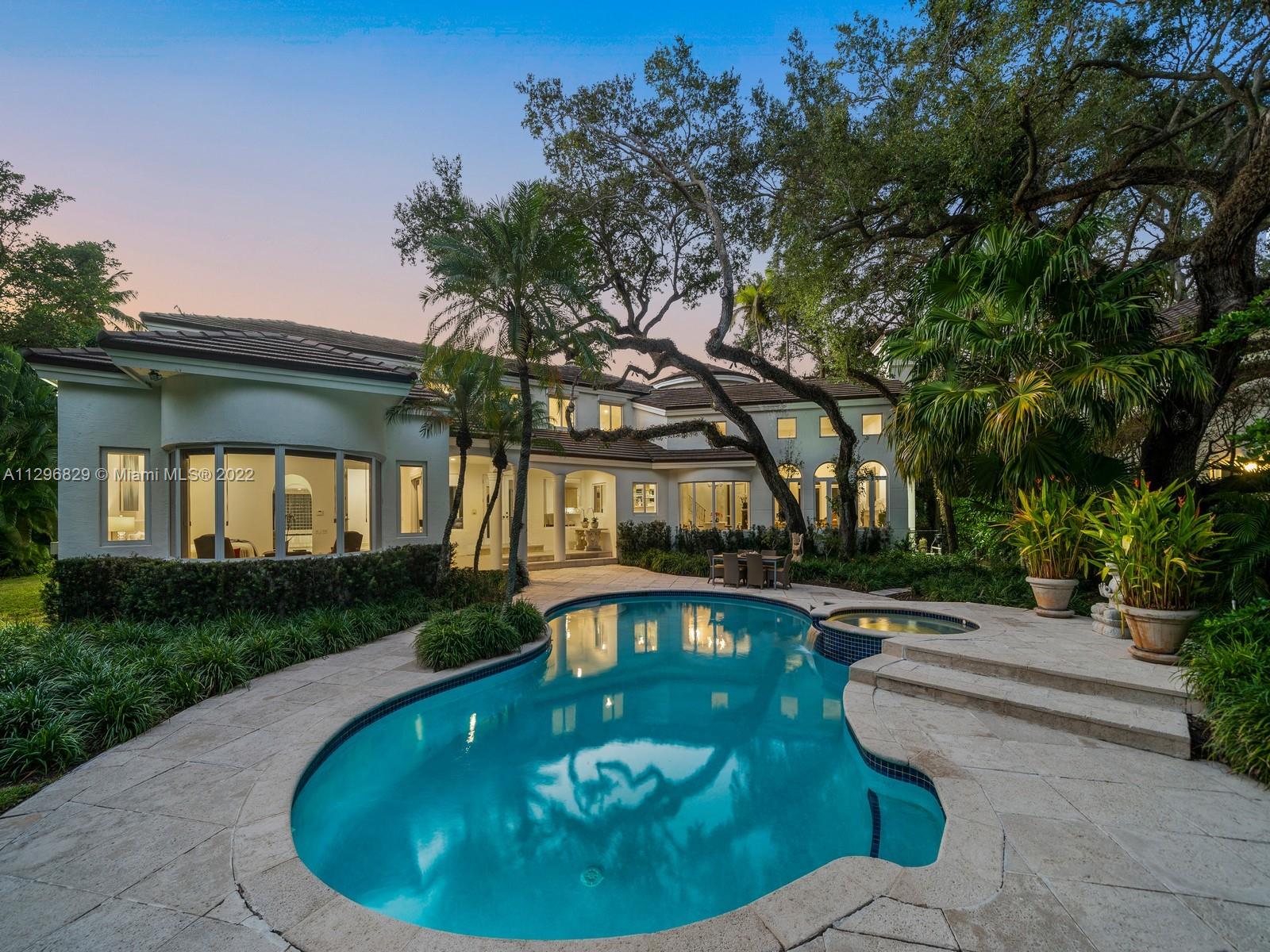 Magnificent two-story home in "Arboretum Estates", a private gated community of 11 homes in prestigious North Pinecrest. Discover a grand foyer entrance featuring high ceilings and elegant formal living/dining room with fireplace and bay windows. Enjoy a large and open chef’s kitchen with breakfast area, family room and wet bar. Huge Master suite located on ground floor with sitting area, walk-in closets, and resort-style bath with jacuzzi tub and shower. A tropical outdoor oasis awaits with large pool/spa, covered terrace and a serene garden with mature oaks. Additional Features: cul-de-sac home, impact windows/doors, full house generator and 2.5-car garage. In proximity to Wayside Market, Coral Oaks Tennis Club and Pinecrest Elementary School.