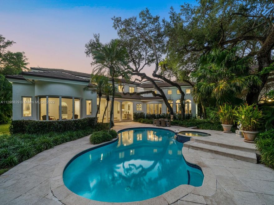 Magnificent two-story home in "Arboretum Estates", a private gated community of 11 homes in prestigious North Pinecrest. Discover a grand foyer entrance featuring high ceilings and elegant formal living/dining room with fireplace and bay windows. Enjoy a large and open chef’s kitchen with breakfast area, family room and wet bar. Huge Master suite located on ground floor with sitting area, walk-in closets, and resort-style bath with jacuzzi tub and shower. A tropical outdoor oasis awaits with large pool/spa, covered terrace and a serene garden with mature oaks. Additional Features: cul-de-sac home, impact windows/doors, full house generator and 2.5-car garage. In proximity to Wayside Market, Coral Oaks Tennis Club and Pinecrest Elementary School.