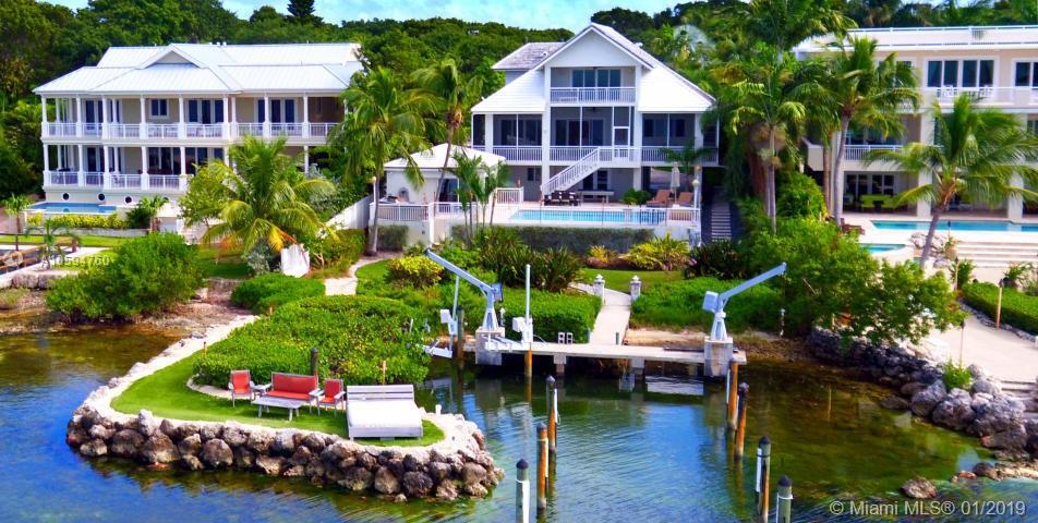 This spectacular bay front home with basin docking, sandy beach and pool is definitely modern ''Coastal Chic''. Recently renovated optimizing modern open space and sunset views of the Florida Bay. Gated and landscaped for privacy this home is a must see! 3rd floor master suite, office or 6 th bedroom, 2 car garage and pool-side gazebo complete with bar and a full bath make this the ultimate in Keys lifestyle.