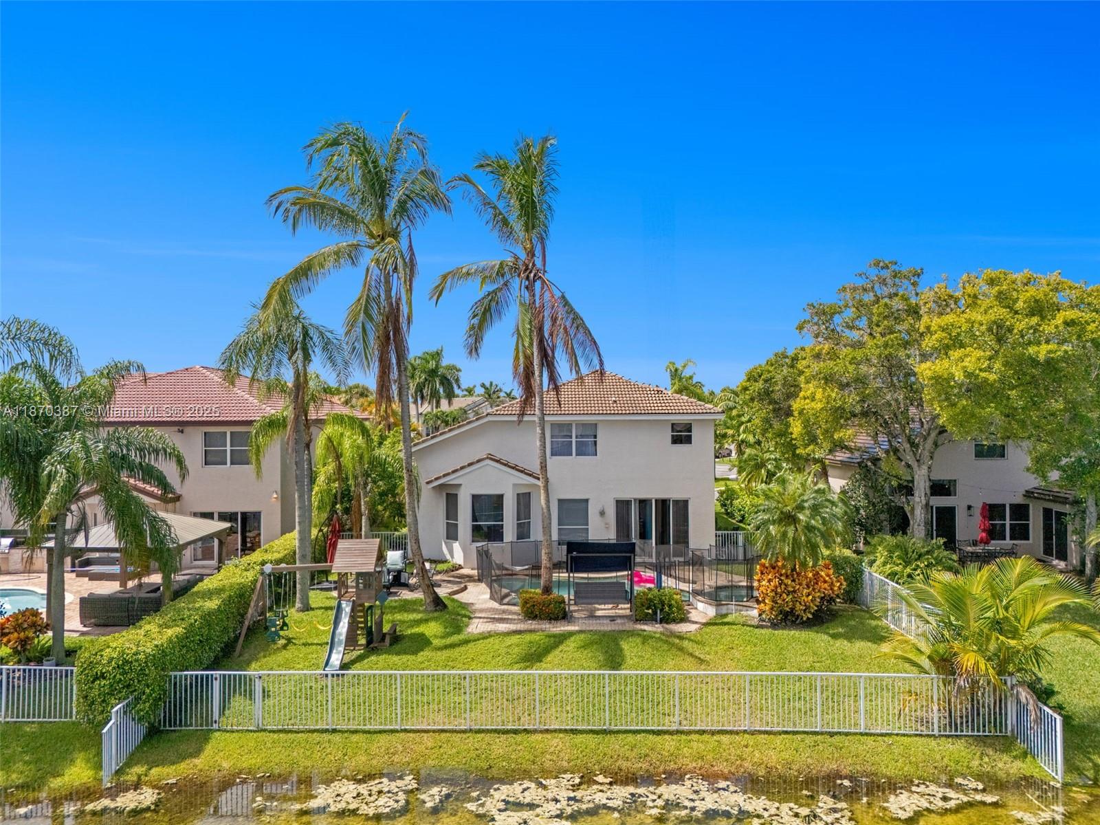 Welcome to SilverLakes, one of Miramar’s premier gated communities. This 4-bedroom, 3-bath waterfront home features over 3,000 sq ft of living space with soaring ceilings, abundant light, and a flexible layout. The first floor offers a full bedroom and bath, formal living and dining areas, and a spacious family room. The eat-in kitchen overlooks the pool, patio, and wide canal views—perfect for entertaining. Upstairs, the primary suite boasts a sitting area, dual walk-in closets, and two bathrooms in a unique his-and-hers design. Two additional bedrooms share a Jack & Jill bath. Enjoy resort-style amenities including pools, tennis, playgrounds, and fiber internet, all minutes from top schools, shopping, dining, and highways.