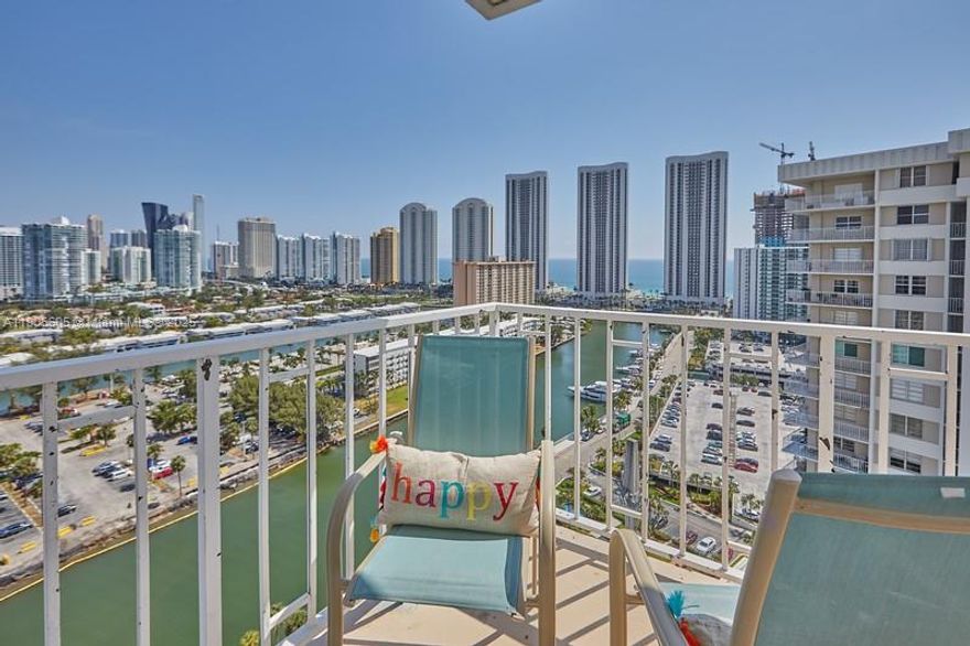 Opportunity to Live in Sunny Isles, or have a second home at an incredible price! This Large 2 bedrooms 2 bathrooms, is offer remodeled, with real hardwood floors, in a light color, high impact windows in all of them, enjoy sunrise and sunsets from its large wrap around balcony, with views of ocean, and the Sunny Isles skyline. Walk to the beautiful SIB beaches across the street or lay down in one of the pool chairs over the Bay. Amenities also include gym, billiards, tennis courts, basketball courts. Minutes to Ball Harbor Shops, and Aventura mall as well. Convenience store in basement. Unit has a storage. Maintenance includes trash, water, sewer, internet cable and A/C Text Agent