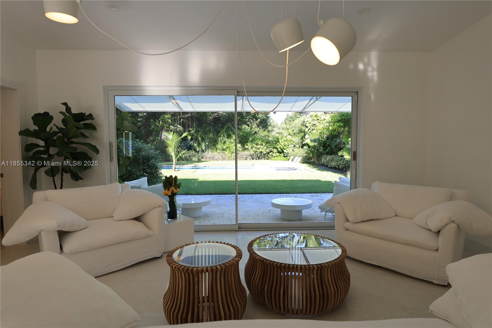 Owner will consider shorter than a 1-year term for rental! Exquisitely fully furnished modern living space with high ceilings and open airy spaces. White throughout, including large cool terrazzo tiles in the living area and wide-planked Siberian white wood in the bedrooms. High impact windows and doors and custom closets. Immaculately maintained high-end kitchen including marble counters and top of the line appliances. Large lush private canopied/tropical backyard with mature trees and nearly 1/2 acre fenced property with saltwater heated pool. Outdoor shower and patio with retractable awning for all year round entertaining. A tropical paradise! NO PETS ALLOWED.