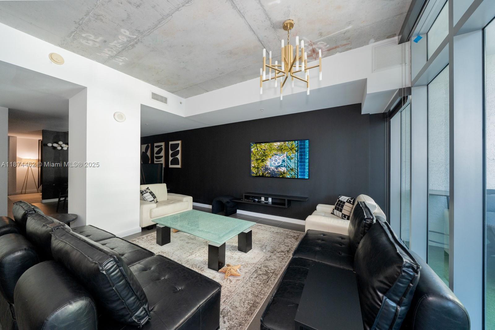 Furnished studio + den at 4 Midtown featuring 9-ft exposed concrete ceilings, modern finishes, and floor-to-ceiling windows with abundant natural light. Sleek kitchen with stainless steel appliances and ample storage. The unit is uniquely convenient, its parking space is located on the 2nd floor, so there’s no need to take the elevator. Residents enjoy resort-style amenities, including a state-of-the-art fitness center, pool, spa, steam room, sauna, and concierge. Ideally located in the heart of Midtown Miami—just steps from top dining and cafés, and minutes to Wynwood and the Miami Design District.