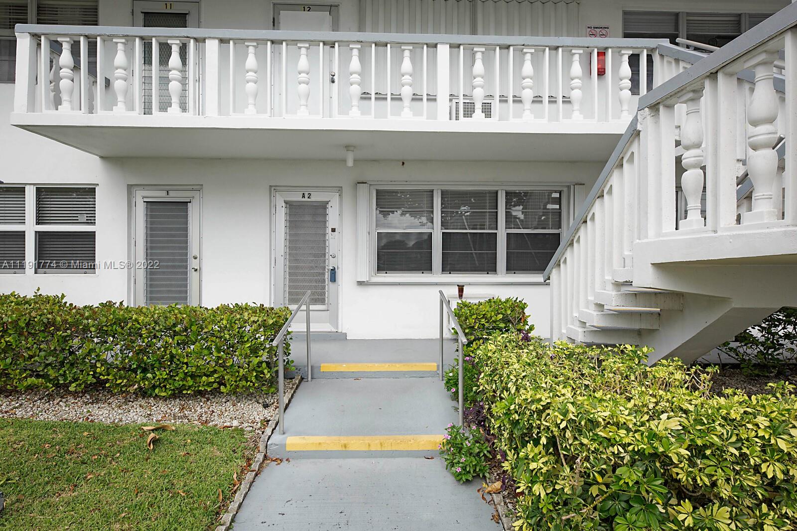 Welcome to this spacious 1 bedroom, 1 bath turnkey, 1st floor garden style condominium in the heart of Century Village. Enjoy local nature while sitting on your enclosed back porch facing the canal and abundant with birds and even some fruit trees. Very private serene back porch! Large open floor plan with many upgrades including newer stainless appliances, new hot water heater, newer AC units, tile floors, fully upgraded open kitchen with bar for dining, hurricane shutters attached. Laundry is on site in the building. This is a 55+ community with full amenities, owner may lease after owning for 2 years. Desk does not convey with sale.