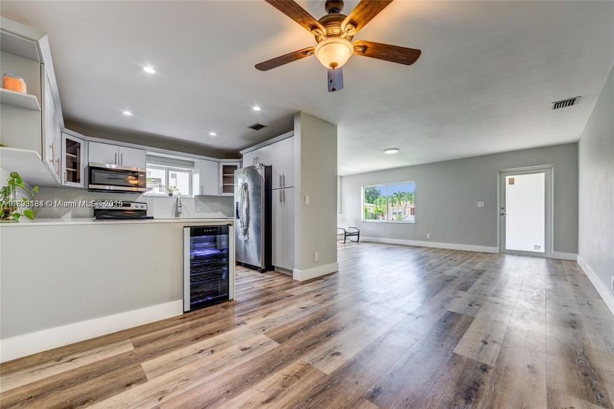 Upscale bright bungalow minutes from Gables, Grove, and Brickell.  Features include open floorplan, wood floors, spacious rooms, glass-enclosed showers, wine refrigerator, electronic locks, LG washer and dryer, and Nest thermostat.  Walk to shops, restaurants, parks, and public library.  3rd bedroom can also be sued as an attended living area, den, or office (with a separate entry door).  Brand new GE refrigerator.  Fully fenced small back yard (pets permitted) with patio, hammock, and Mamey tree, (bbq grill permitted).   Water filtration system installed.  All hurricane window and doors.  Security system available.