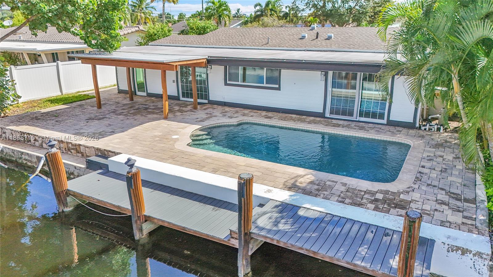 Waterfront pool home featuring 3 bedrooms, 2 bathrooms plus a flex room/office and 1 car garage with 70 ft of waterfront. Amazing location!! Live the South Florida dream in this beautifully updated home with your own dock space, paver pool deck, privacy fence & covered pergola! Enjoy boating, entertaining, and effortless access to the ocean with only 1 fixed bridge. Updated kitchen with solid wood cabinets, SS appliances, wine cooler and granite countertops, Impact doors and windows, tile floors and a large laundry room. Master suite with large sitting room and built-in closet. Circular paver driveway for plenty of parking. No HOA! Minutes to Pompano Beach & the newly renovated Pier, restaurants, shopping, golf and more. You can't ask for much more as this property checks all the boxes!