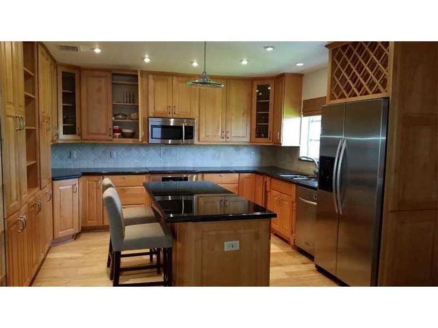 Fantastic opportunity. This 3/2 home is bright & cheerful. Formal living/dining room. Custom maple kitchen w/granite countertops, tons of storage space, island & stainless steel appliances. Brand new modern hall bath being completed now.  Spacious master  bedroom w/custom walk-in closet and dressing area. Neutral wood floors & custom bamboo window coverings throughout. Meticulously maintained yard w/covered back patio. Accordion shutters. Home is located on a cul-de-sac, on a private, quiet street.