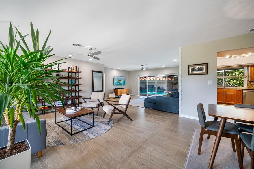 Stunning reimagined Mid-Century modern in sought-after East Miami Shores, steps from Biscayne Bay. This 3BR/3BA gem sits on an oversized 8,368 SF lot and blends timeless architecture with modern upgrades. Bright open floor plan showcases new flooring, designer-finished baths, and a sleek kitchen with premium appliances. Impact windows, lush landscaping, and a screened-in pool patio create a private resort-style retreat perfect for entertaining. Rear-entry 2-car garage offers storage with flexible potential for guest suite, office, or gym. Ideally located near top schools, golf, tennis, aquatic center, parks, shopping & dining offering luxury living and everyday convenience.