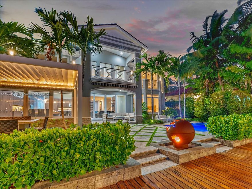 Welcome to an unparalleled masterpiece in coveted Rio Vista. This estate offers the best of both worlds—an entertainer’s dream and a tranquil haven. With an expansive open floor plan & seamless indoor-outdoor flow, the home blends luxury, relaxation, and functionality. Host friends around the outdoor kitchen while enjoying the fully climate-controlled pool featuring jets in every corner. The private 75ft dock offers easy access to the ocean, setting the stage for unforgettable sunset cruises or fun-filled days on the water. At night, the home comes alive with city lights and serene water views accentuated by the custom hand-crafted globe fire pit. The self-contained 500+ bottle wine cellar, theater room, office, gym + sauna, and elevator are all designed to provide opulence and wellness.