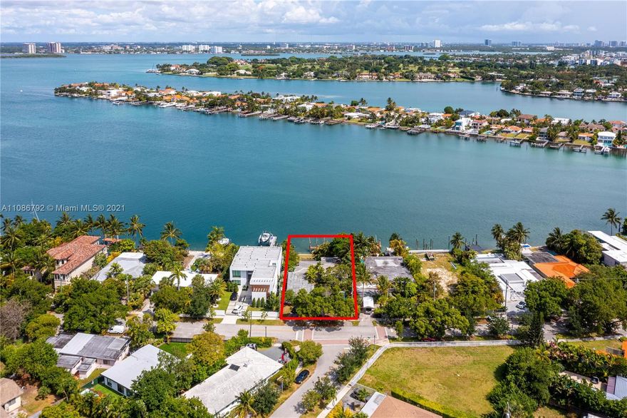 Classic 1950s Waterfront home located on guard gated Biscayne Point Island. Bright, open, and spacious with a total of 4 bedrooms and 3 baths, plus  2 car garage on an oversized 11,250 SF lot with 75 Ft on the water, perfectly positioned to maximize the wide bay views.   Eat-in kitchen, formal living and dining, plus waterfront family room surrounded by floor to ceiling glass sliding doors.   Update, renovate, or recreate to build your dream home in a desirable and secure location. Ideal for boaters too with dock, wide water open bay  access, and no fixed bridges!