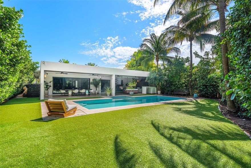 Wonderful 4 bedroom plus den home in premium Miami Beach location across the street from the Ritz Carlton single family homes and walking distance to the park. The Zen home is nestled in an oversized lot, welcoming you to a sanctuary courtyard. An incredible pool loggia surrounded by double-height greenery and hedges, a plethora of open green space for sun lounging. The outdoor living rooms boast a table for 14, hanging tulip basket seating, built in BBQ and bar. Just perfect for entertaining. The well-appointed interiors feature hardwood flooring throughout, multiple living rooms surrounded by glass walls, marble baths, primary suite with oversized walk ins, spa bath and a wonderful chef’s kitchen with Arizona Margarita stone, custom cabinetry and Miele/Subzero appliances. Gated.