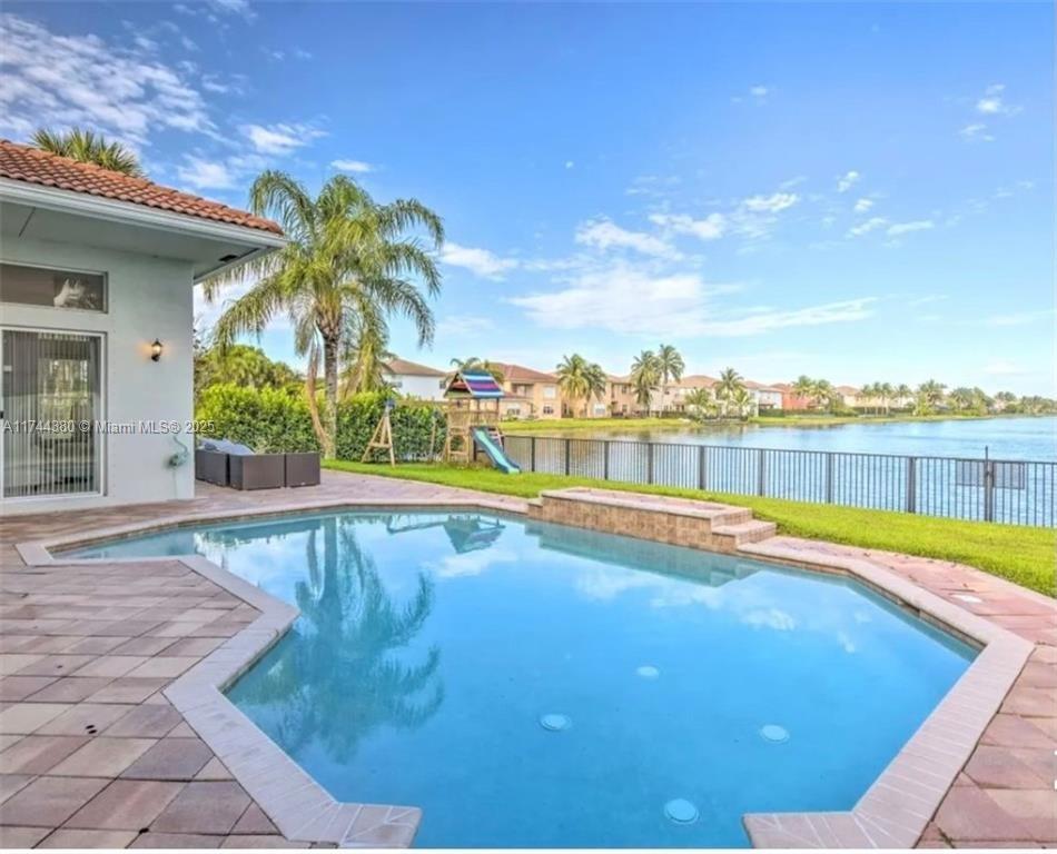 Breathtaking Water Views! This stunning 4-bedroom, 3-bathroom home boasts the best views in the community, filling the space with natural light and serene waterfront scenery. The beautifully renovated kitchen features luxurious white quartz countertops and sleek stainless steel appliances, perfect for modern living. Step outside to your heated saltwater pool, an ideal retreat for relaxation and entertaining. Located in a low HOA community with top-tier amenities, a manned gate, and convenient access to shopping and top-rated schools, this home truly has it all!