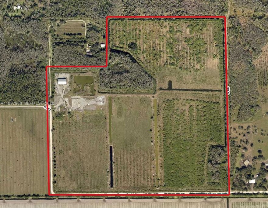Positioned in a rapidly growing corridor just south of LaBelle and conveniently located between LaBelle and Immokalee, this expansive 144.5-acre property at 960 G Road presents a prime opportunity for agricultural investment or rural enterprise. Surrounded by warm climate conditions ideal for year-round productivity, the land is well-suited for a wide variety of uses including row crops, livestock, or other agricultural ventures. The property features a substantial 55' x 125' steel warehouse, offering excellent space for equipment storage, operations, or future improvements. Existing infrastructure includes well, septic, and electrical service already in place, providing a strong foundation for development or continued agricultural use. The acreage is fenced, though portions will require repair, and includes canal systems that may assist with drainage or irrigation. With road frontage on two sides, access and flexibility for future use or division are key advantages of this tract. Please note: The property is being sold As Is. It has experienced vandalism, and the current absentee owner has not been able to oversee cleanup or restoration. This is reflected in the price. Whether you're expanding an agricultural operation, seeking a land investment, or looking for a large private holding in a growth area, this property offers significant upside at an attractive scale.