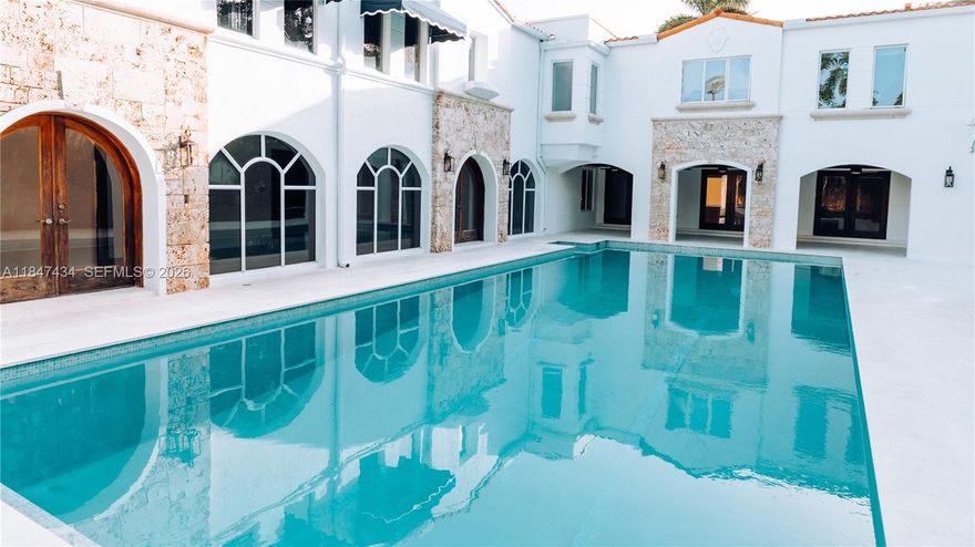 Nestled in the heart of Coral Gables, this sophisticated and impeccably maintained estate spans over 12,327 square feet on a lush 31,529 SF lot. Originally built in 1936, the residence blends timeless elegance with modern luxury, offering 7 bedrooms, 10 full bathrooms, and 2 powder rooms. Highlights include: A dramatic double-height foyer and expansive formal and casual living areas. A designer chef’s kitchen with top-of-the-line appliances and custom cabinetry. Additional spaces such as an executive office/library, game room, and media room. Elevator access, custom finishes, and volume ceilings throughout. The exterior features a resort-style pool with a new heater, barbecue area, and a 3-car garage and large motor court. Recent upgrades include a new roof and AC systems.