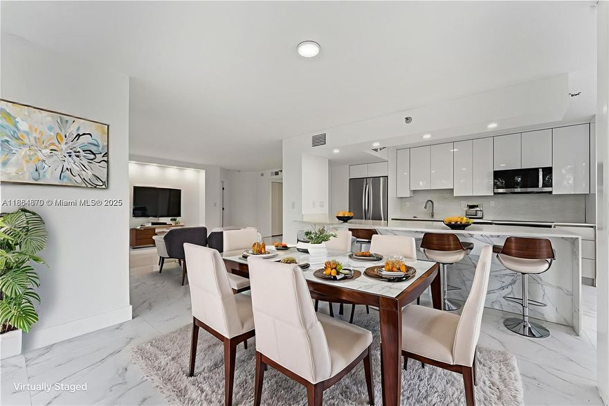 Luxurious and modern corner condo at Mystic Pointe with a spacious open floor plan, unique floor-to-ceiling IMPACT windows, and abundant natural light. This residence showcases top-of-the-line upgrades with porcelain tile throughout, a brand new open-concept kitchen designed with premium finishes, and new state-of-the-art appliances. The primary suite features an updated en-suite bath with dual vanities, antifog mirror, linear drain, and freestanding soaking tub. New washer and dryer. Designer style custom closets provide ample storage. Additional improvements include upgraded electric and plumbing. Community amenities include gym, tennis, pickleball, restaurant, marina, dog park, EV stations, and more. Close to houses of worship, beaches, Don Soffer Trail, Aventura Mall, and airports.