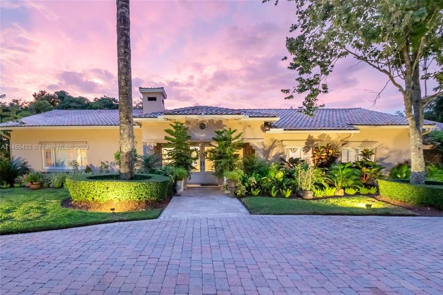 Exquisite, 5 bdrm/ 4.5 bath home tucked away on an expansive, gated, corner lot, in a fantastic location in Pinecrest. Lovely formal living w/ fireplace, marble flooring. Sophisticated formal dining. Elegant, remodeled kitchen w/ stately white cabinetry, quartz countertops, large island w/ bar seating, gas stove, stainless appliances. Grand bonus rm perfect for playrm, theater. Spacious family rm. Flexible floorplan. Spectacular grounds w/ summer kitchen featuring grill, refrigerator, sink & covered seating area. Additional structure, perfect for the outdoor office this winter! Large swimming pool w/ water feature, travertine patio, playground, treehouse & sprawling lawn perfect for a soccer game or the pets to run.  Impact windows, underground electrical lines. Circular paver driveway.