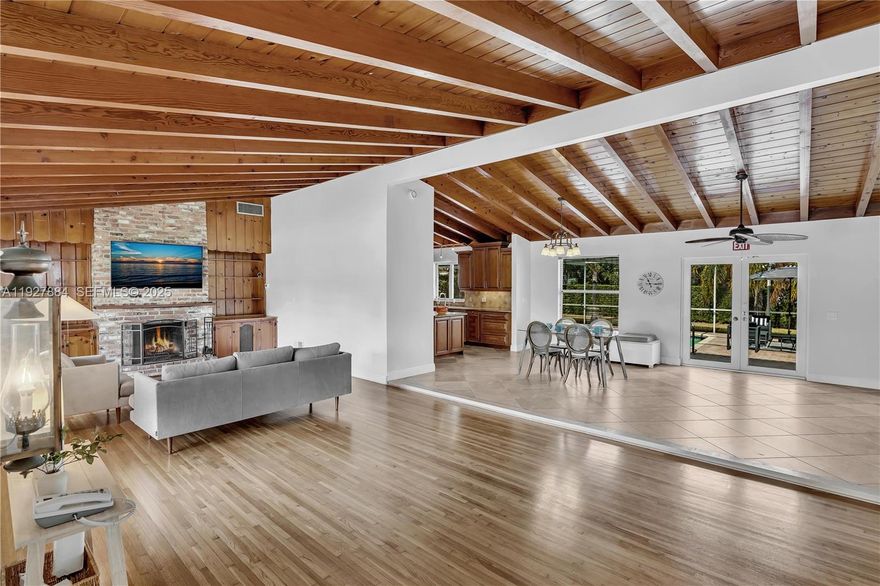 Welcome to 3437 Buchanan Street, a charming 3-bedroom, 3-bathroom pool home in Hollywood Hills. This bright, inviting residence sits on an expansive 12,000+ sq ft lot and features vaulted Florida Pine wood-beam ceilings, hardwood and tile flooring, and a spacious kitchen with granite countertops and stainless steel appliances. The open-concept living area includes a brick fireplace and large windows overlooking the backyard’s screened-in pool and lush lawn. The primary bedroom offers direct access to the pool deck. Two interior bathrooms feature generously sized showers, and the third bathroom provides convenient access for poolside use. Additional highlights include hurricane-impact windows, a two-car garage, and ample driveway parking. Property may be used for short-term rentals.