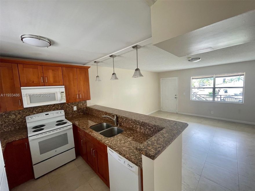 Spacious upgraded in highly desirable residential area. Tiled throughout with lots of closet space. Large new open Kitchen. Central AC, Laundry facility onsite. assigned parking space .Rent including water Easy approval.