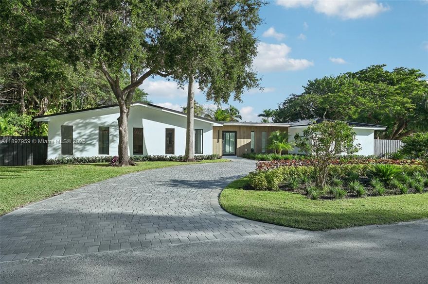 Experience modern luxury and timeless elegance in this stunning 4-bedroom, 3-bath corner-lot residence on a spacious 0.46-acre lot in Palmetto Bay. This beautiful home features a bright open layout with sleek custom finishes and abundant natural light streaming through floor-to-ceiling impact glass. The gourmet kitchen offers premium appliances, a large island, and bespoke cabinetry flowing seamlessly into the living and dining areas. The primary suite provides a serene retreat with a spa-inspired bath and custom closets. Step outside to your tropical oasis with a sparkling pool, lush landscaping, and a majestic banyan tree—perfect for relaxing or entertaining. Ideally located near top-rated private schools, parks, and the Deering Estate.