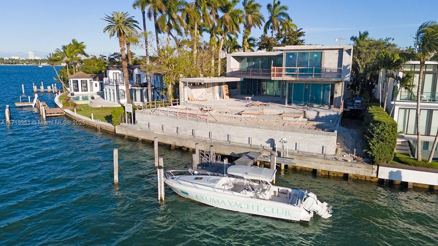 This brand-new, elevated, luxury home offers over 9,000 sqft of contemporary living with open water bay views and Miami skyline sunsets. Boasting 6 spacious bedrooms, 6 plus 2 half bathrooms, the residence features exquisite interior finishes. Custom kitchen by Ernestomeda with high-end appliances by Wolf, Miele, and Sub-Zero. Custom bathrooms by Casabath. White oak ceilings in the primary bedroom and dreamy walk-in closet, floor-to-ceiling glass & stone walls in the primary bath. The open floor plan seamlessly transitions to an outdoor oasis, complete with kitchen, dining area, pool & dock on 104 ft of water frontage. The rooftop offers stunning 360 degree views while the understory features a 3-car garage, additional covered parking and elevator access. Expected completion August 2025.