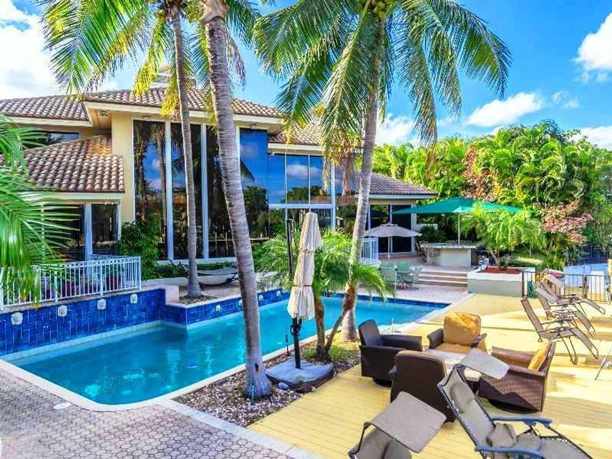 Coveted Bay Colony waterfront estate. This contemporary home has 6 Bedrooms 7.5  Bathrooms, plus an office and a theater and is one of the largest homes in all Bay Colony. Features a grand entrance with floor to ceiling custom windows overlooking the pool /spa and your private dock. Grand spiral staircase and elevator. Great home for entertaining with two fireplaces, two laundry rooms and more. Situated on a cul-de-sac. Armed gated 24 hour security. Close to beaches, shopping and Pine Crest schools.