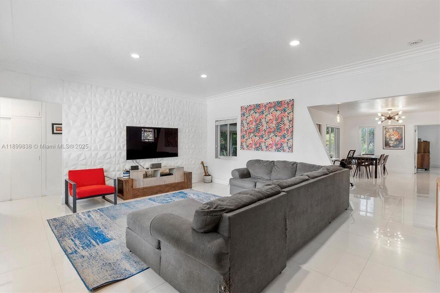 Amazing opportunity to own a true waterfront gem in North Miami! This beautifully updated 3BR/2BA home sits on an oversized lot along the Biscayne Canal, offering over 2,400 SF of living space plus a 700 SF detached garage/studio right on the water. The open, updated kitchen shines with granite counters, stainless appliances, and generous storage. White tile floors and impact windows throughout. A spacious primary suite anchors the split-bedroom layout, while a large screened porch overlooks lush native landscaping and mature fruit trees. Natural gas line. Enjoy tranquil canal views and access now—and look forward to direct Biscayne Bay access coming by 2030.