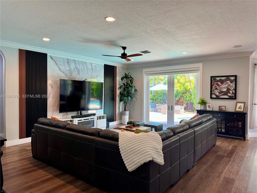 Welcome to your dream home! This beautifully remodeled 5-bedroom, 3-bathroom home, featuring an amazing pool and waterfall, is nestled in a private, beautifully landscaped tropical oasis on a spacious corner lot in a quiet, well-maintained neighborhood with low HOA fees. Completely remodeled bathrooms, an elegantly designed kitchen, a spacious family room, and a stunning two-story living room with a water filtration system, air purifier, and automatic air conditioning drain cleaning system are included. High-impact, energy-efficient windows and doors are also featured. A 3-car garage with a race deck floor and air conditioning is provided. There is also a community pool, fitness center, social club, tennis courts, pickleball courts, and a playground. Don't miss this opportunity!