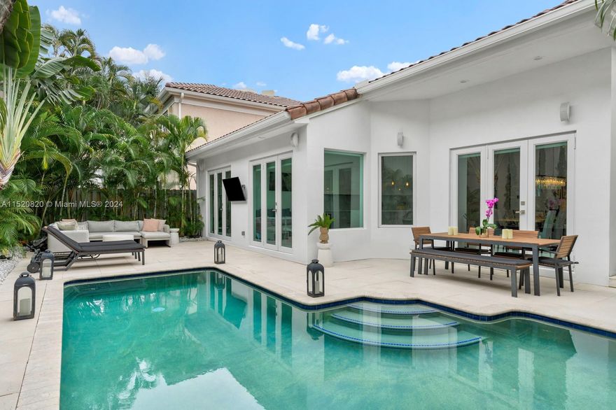 Welcoming you to the privately gated Golden Gate Estates community. This residence is nestled in a quiet cul-de-sac covered in lush landscaping and is a rarely offered one-story home with double-height ceilings throughout. The attention to detail, from the Control-4 system, natural light, and sleek finishes, creates an inviting atmosphere. 3 expansive bedrooms and a spacious den & staff quarters provide versatility. The kitchen offers Smeg/Subzero appliances, oversized island, marble counters & dual ovens. The primary suite, with spa-like bath & custom closets, feels like a private retreat. The backyard features a private pool and al-fresco dining options. Neighborhood amenities include a private marina, tennis court, playground, 24-hour security, and close proximity to the ocean.