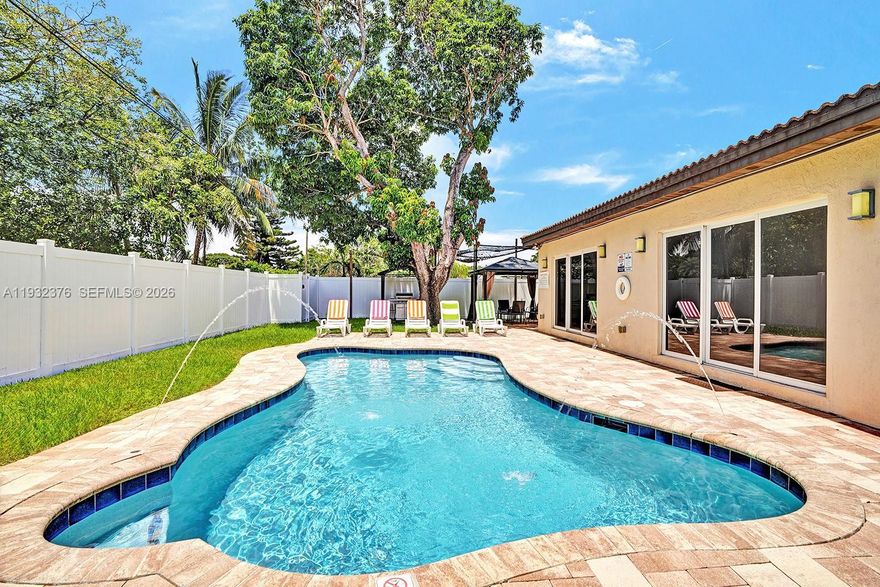 This beautiful 4-bedroom, 3.5-bath pool home in the desirable neighborhood of Hollywood Lakes was fully rebuilt in 2017 including new walls, new layout, new plumbing, electrical, roof, etc. Basically brand new house! The property was thoughtfully updated throughout including impact windows and doors. The sleek, modern kitchen serves as the heart of the home and flows seamlessly into expansive living and dining areas, creating an ideal setting for both everyday living and entertaining. Outdoors, enjoy a private retreat featuring a heated pool, paver patio, and fully fenced yard. With a proven history as a high-performing short-term rental, this property presents a rare opportunity for investors or buyers seeking an exceptional primary residence with strong income potential.