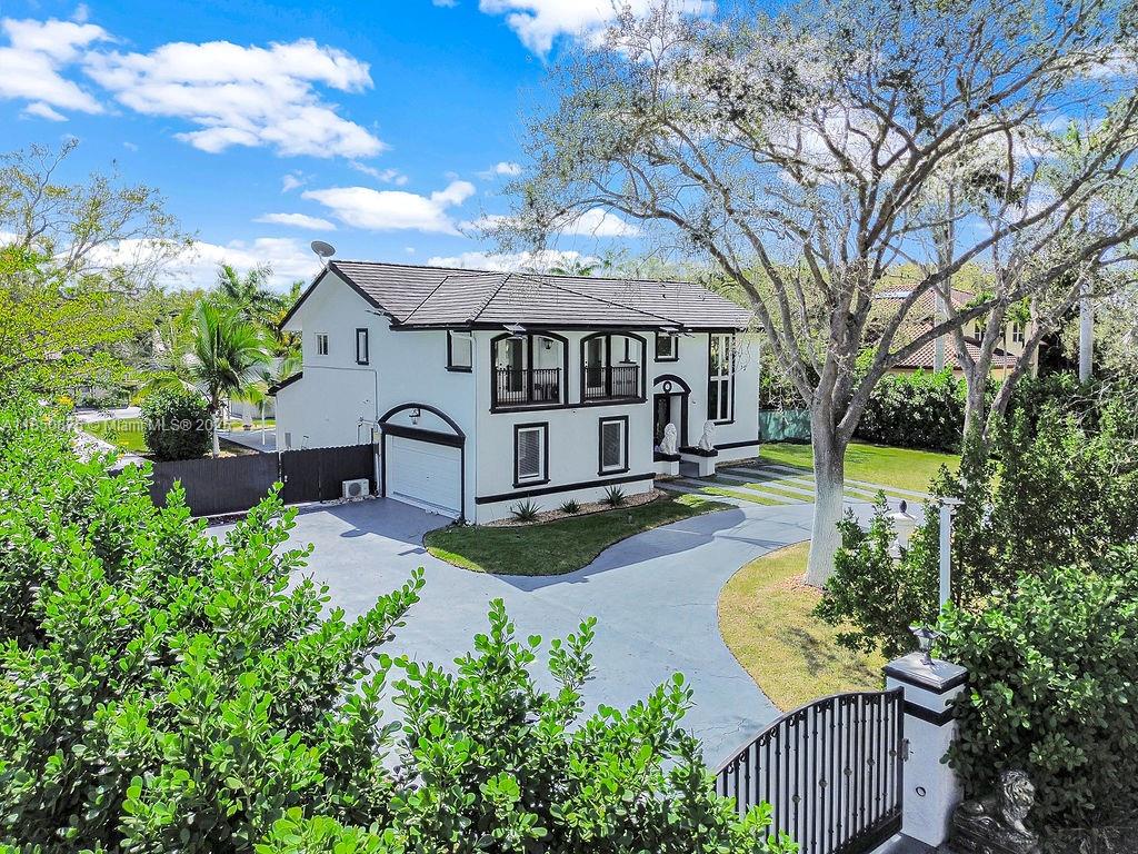 Experience ultra-modern living in this fully reimagined 2023 two-story estate, offering exceptional privacy and modern design in the heart of Pinecrest. Greeted by an oversized circular gated driveway, this stunning home features marble floors throughout, an open-concept layout, and a gourmet kitchen equipped with top-tier appliances. The main home features a 1st-floor en-suite bedroom & cabana bath, while the primary suite is located privately upstairs. Enjoy a covered pool, summer kitchen, a separate guest house with 1 BD & 2 full BA, and a versatile backyard with space to re-convert the tennis/paddle court or use as extra covered parking, ideal for car collectors. Located near top-rated schools, fine dining & shopping. Also available for lease!