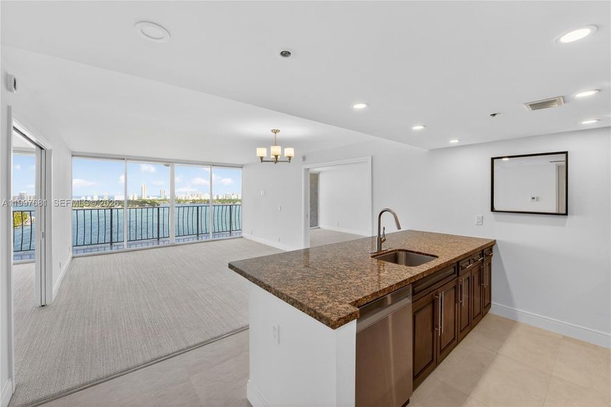 Beautifully maintained 2-bedroom, 2-bath waterfront residence in Grandview Palace’s most desirable line, offering sweeping east-facing views over the bay and Normandy Island. This split-plan layout is enhanced by high-end carpeting throughout the bedrooms and living areas, creating a soft, elevated feel that sets the tone from the moment you enter. Luxury pocket doors add flexibility and a more open-concept flow, while the full-width balcony spans the entire residence and is accessible from both bedrooms and the living room, allowing every room to connect to the view. The open kitchen features generous counter seating and flows comfortably into the main living space, while the in-unit washer and dryer add everyday convenience. Located in a full-service waterfront building with 24-hour security, pool, fitness amenities, marina, ground-floor shops and restaurants, plus two parking spaces.