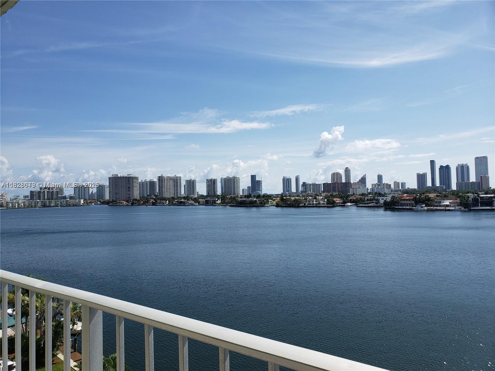 Spacious 1-Bedroom, 1.5-Bathroom Condo with Breathtaking Water Views. One of the best units at the Reef Club, offering panoramic, unobstructed views of the bay and Intracoastal from the top floor. This beautifully maintained residence features a spacious open floor plan, an open balcony, and new kitchen appliances, including a convenient pass-through window to the dining area. The large primary bedroom boasts a walk-in closet and an ensuite bathroom, while the additional half bath provides extra convenience for guests. This immaculate unit is ready to move in, making it a perfect opportunity to enjoy waterfront living at its finest.