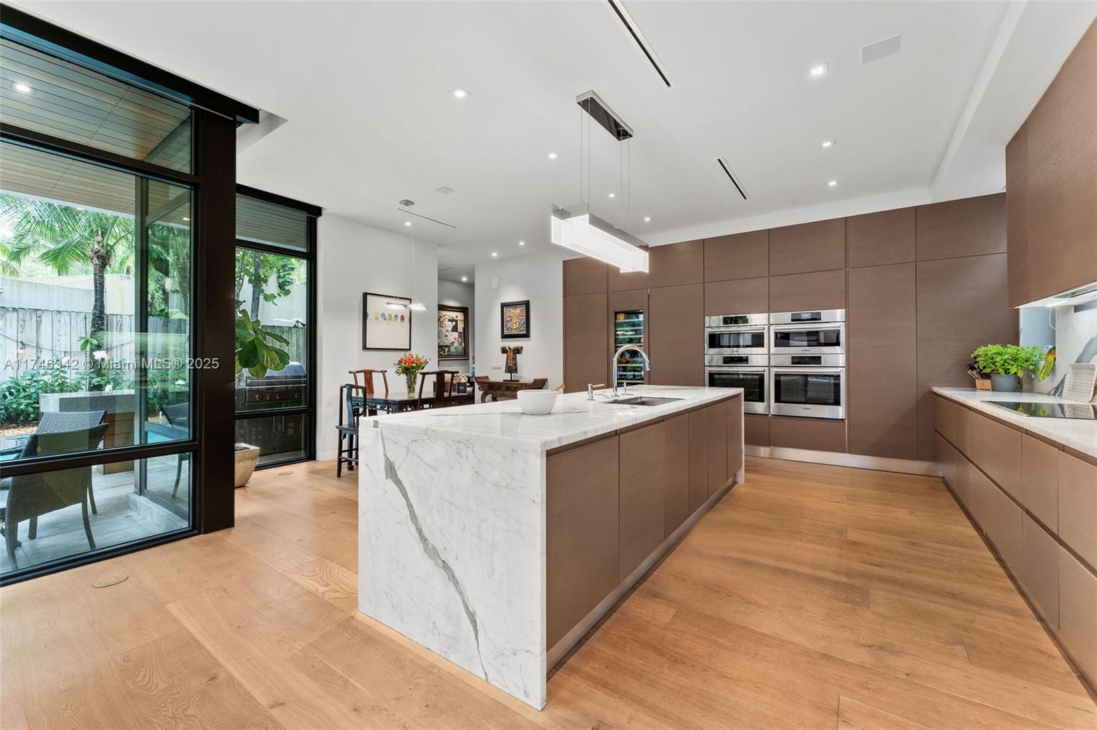In the heart of a coveted North Coconut Grove street, is a finely crafted home on a 9000 sq ft lot. Built by and for a prominent South Florida Developer & his wife, no expense or detail was spared. This was not a “spec house” and it shows! Heated 40 ft lap pool, a sleek Italkraft kitchen, Bosch appliances, perfectly matched Calacatta marble, 4 ovens (including steam), wine cooler, French Oak floors throughout. The primary is a sanctuary with a spa-like bath. For late-night cravings, a “midnight bar” adds an extra touch of indulgence. Take the elevator to your rooftop terrace, ideal for alfresco dining. Walk/ bike to the Village & Biscayne Bay. Minutes to Brickell, the airport, major shopping, Key Biscayne beaches. Luxury, convenience, natural beauty. A.C space 4,478 sq ft (416 M)
.