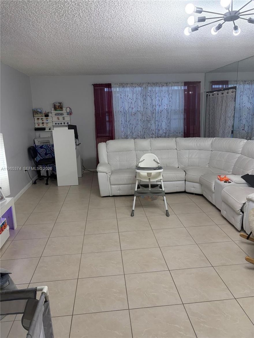 Nice condo centrally located near Dolphin Mall, restaurants and highways. Unit has storm shutters, a new refrigerator, is tiled throughout and is ready to have someone call it home. Community has a pool and tennis court. Laundry room is located right below the unit.