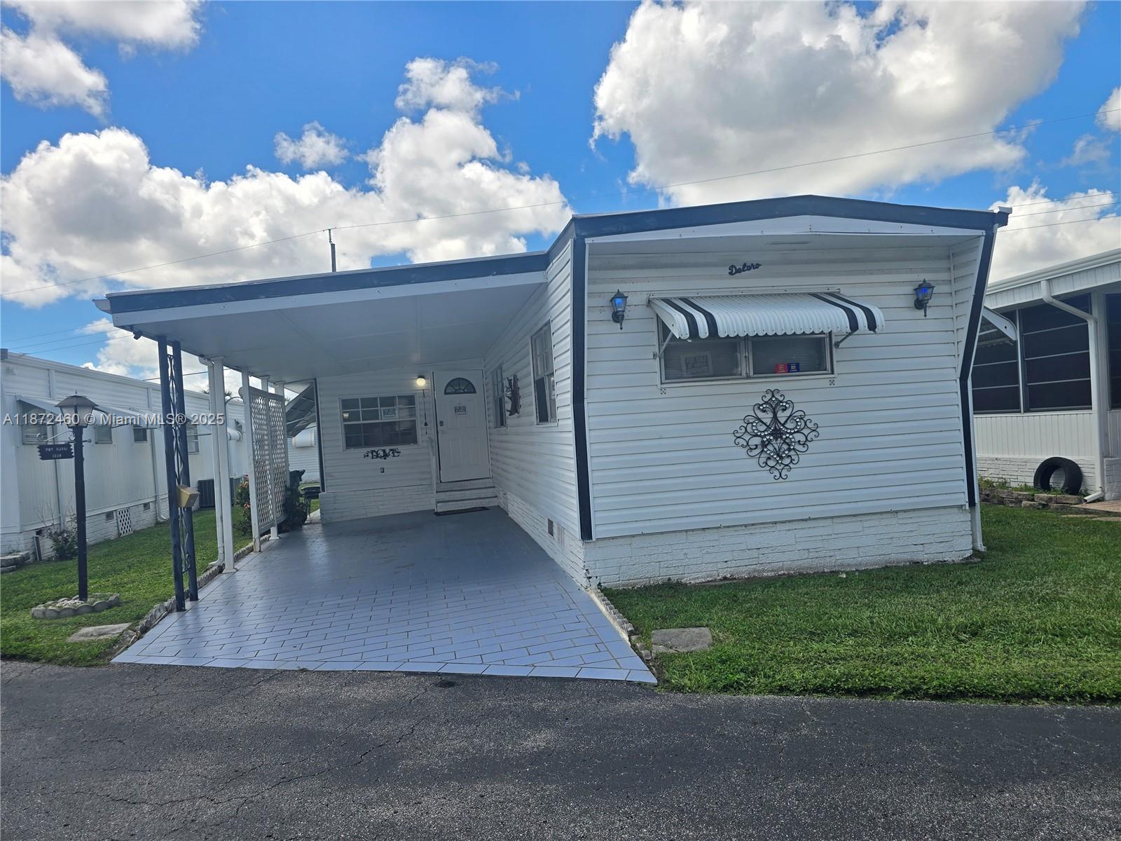 1100 SF manufactured home in Orangebrook, Hollywood, FL, built in 1971 by Delo. It features two bedrooms and two bathrooms. The living and dining areas offer ample space for entertaining. The master bedroom includes a walk-in closet. The kitchen is equipped with appliances such as an oven, refrigerator, and dishwasher, includes a laundry room with a washer/dryer and new central air conditioning, and recently remodeled floors and bathrooms. This community offers residents a variety of amenities, including a clubhouse with a pool, meeting room, and gym. Easy access to nearby shopping, dining, and entertainment venues makes it a convenient and attractive location. With its welcoming atmosphere and convenient location, is the perfect place for residents to enjoy a comfortable lifestyle.