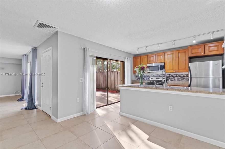 NO HOA FEES FOR ONE YEAR!!! Welcome to this spacious townhome in Waterside Luxury Townhomes. This 2 bed, 2.5 bath home offers 1,288 SF of light-filled living with a private fenced patio. The kitchen features stainless appliances and a breakfast bar. Both bedrooms include ensuite baths and balconies. New Lennox AC install in 2023 with 10 year warranty. Hurricane shutters throughout and in-unit laundry. Fence replacement scheduled this year by the COA. Association fees cover exterior maintenance, roof, landscaping, trash, and insurance. Community features a pool and tennis courts. Investor-friendly — rent right away! Close to shopping, dining, I-95, and the Ballpark of the Palm Beaches! Seller to pay one year of HOA fees and a credit of $4,000 for new carpeting.