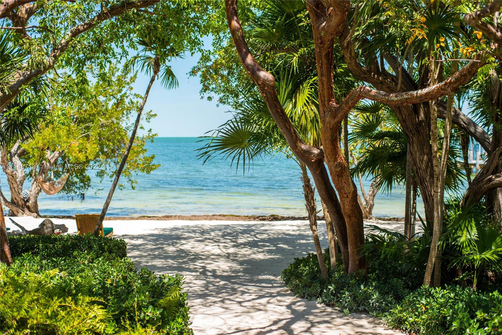 Escape to the jewel of Islamorada, a magnificent estate with sandy beaches, warm Bay waters, and glorious sunsets. Built in 2006 and carved from a 4-acre hardwood hammock, this gem checks all the boxes. A main house comprised of 6 bedrms w/ ensuite baths, splendid social spaces, a kitchen of epicurean magnitude, and spectacular verandas are the foundation of perfection. Special features include Crestron technology, crema marfil floors, impact glass, keystone fireplace, coral courtyard, and breathtaking landscape & lighting. Enhancing this paradise are guest cottage, resort-style pool, boat dock w/ 2 lifts, tennis court, chickee hut w/ bar, and cool fire pit. This spectacular property is offered fully furnished; bring a wide-brim hat, bathing suit, and enjoy salt-life living.