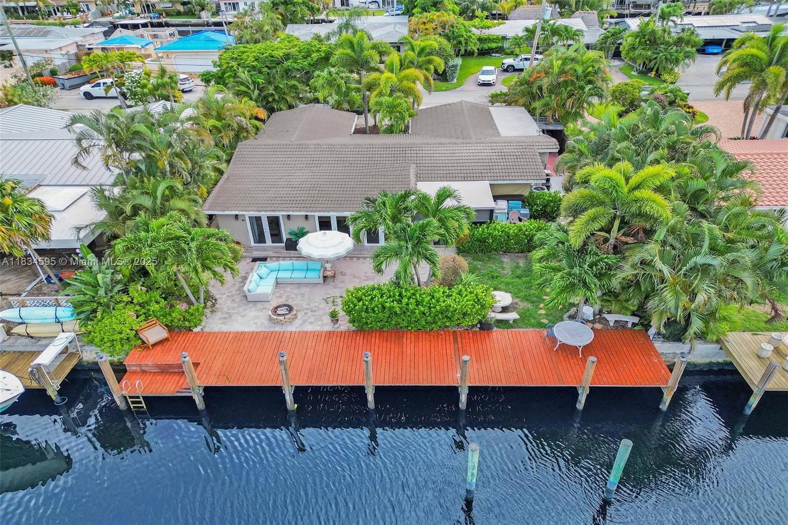 In the heart of Wilton Manors, this 4 BD | 4 BA waterfront home offers the ideal setup for multigenerational living or income potential complete with in-law quarters. Boater’s dream with a private dock & space for a 30+ foot boat just off the North Fork of the Middle River. Ocean Access: 2 fixed bridges. Enjoy water views from nearly every angle! Open kitchen! Flow seamlessly into spacious living & dining areas. A large sunroom & Florida room perfect for entertaining or relaxing. The primary suite includes a sitting area, & ensuite bath. Step outside to your paradise tropical landscaping, space for a pool, and quick access to Wilton Drive’s shops, restaurants, and nightlife, all just 12 blocks away. This rare offering blends waterfront lifestyle, flexible floor plan, & unbeatable location.