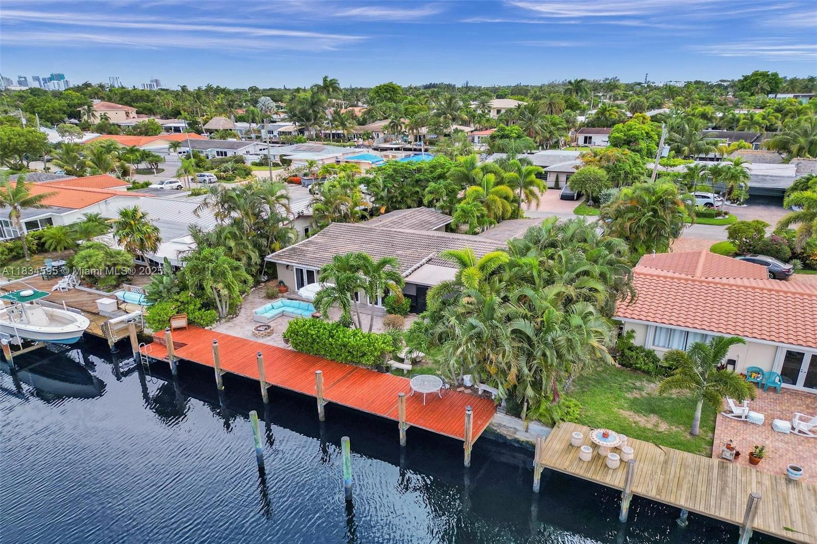 In the heart of Wilton Manors, this 4 BD | 4 BA waterfront home offers the ideal setup for multigenerational living or income potential complete with in-law quarters. Boater’s dream with no fixed bridges and private dock just off the North Fork of the Middle River. Enjoy water views from nearly every angle! Open kitchen! Flow seamlessly into spacious living & dining areas. A large family room & Florida room perfect for entertaining or relaxing. The primary suite includes a sitting area, and ensuite bath. Step outside to your backyard paradise tropical landscaping, space for a pool, and quick access to Wilton Drive’s shops, restaurants, and nightlife, all just a short walk away. This rare offering blends waterfront lifestyle, flexible floor plan, & unbeatable location.