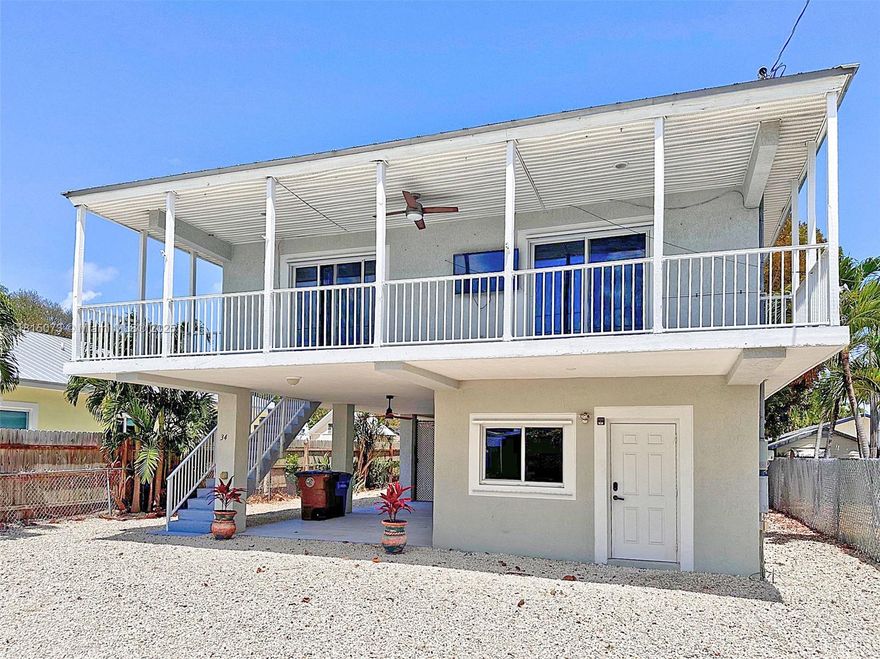 Spacious 4 bedrooms and 3 baths Concrete Home in the Heart of Key Largo - Ideal for large Families or Investment! Upstairs features open concept, cathedral ceilings, 3 bedrooms, and 2 baths. Downstairs is permitted for recreation area, 1 bedroom and 1 bath. Covered carport with the potential for an additional living or custom outdoor entertainment area. Large workshop ideal for a man/woman cave, artist's studio, or home office. Convenient separate laundry areas on both levels. Plenty of room to park your RV, boat, or multiple vehicles. Perfectly located in the highly desirable X-Zone - the highest elevation in the Keys, offering peace of mind and lower insurance costs. Great full-time residence, vacation getaway, or income-producing property. This Key Largo Gem has it all. Move-in Ready!