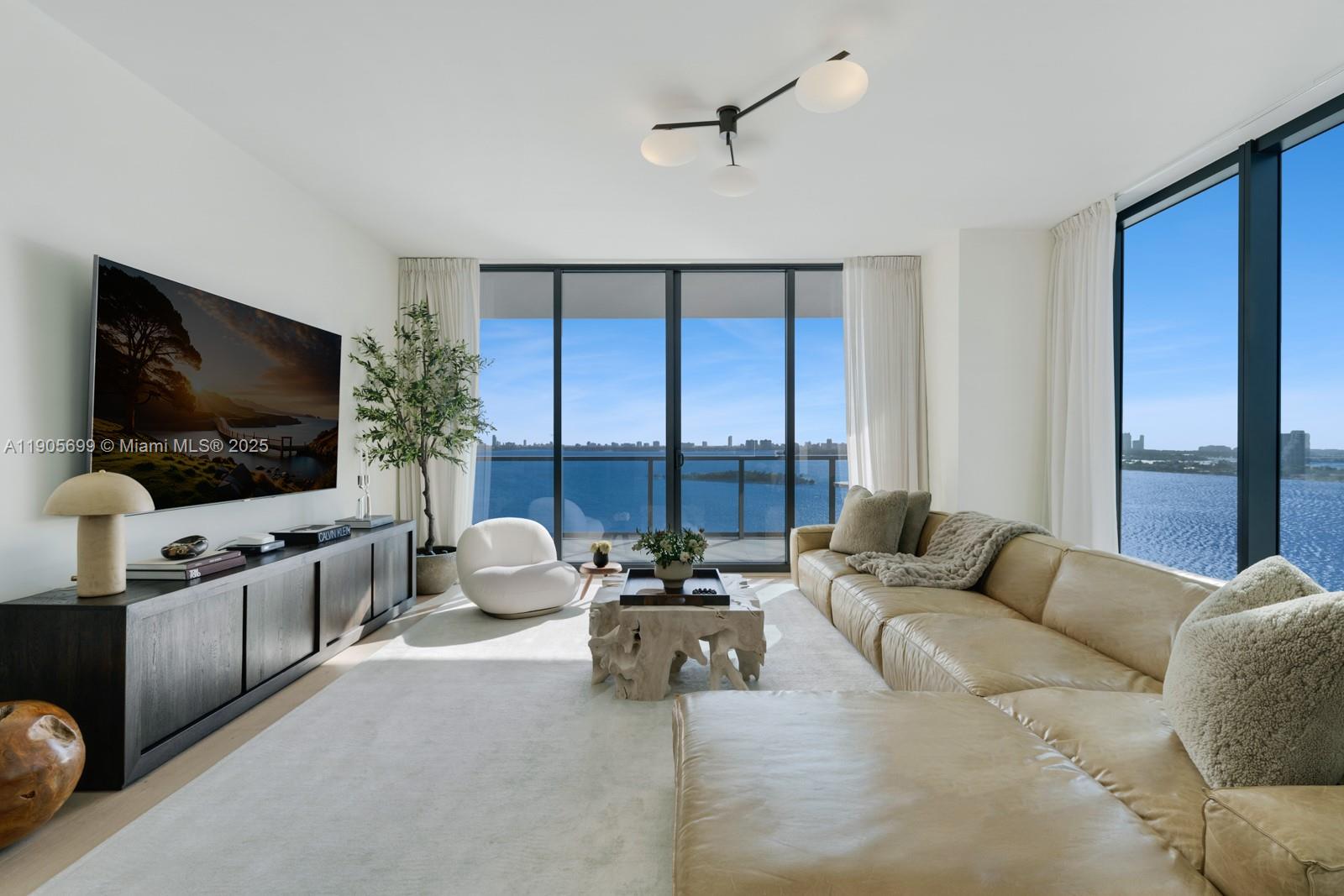 Elegantly curated 3-bed, 4.5-bath residence offering 2,743 sq ft of sophisticated living space at Elysee in Edgewater. Private elevator access ensures exclusivity and privacy. The home is bathed in natural light, showcasing panoramic views of Biscayne Bay, the ocean, and the city skyline from expansive terraces. The residence was meticulously upgraded to include elegant hardwood floors, custom drapery, designer light fixtures, and a fresh, modern paint palette. Elysee residents enjoy a luxurious lifestyle with amenities including a sky lounge, multiple pools, a fitness center and spa, and dedicated concierge services. Located minutes from the Design District and Miami Beach. Ability to convert to a 4-bedroom layout. Buyers may purchase furniture separately. 24 hours notice for showings.