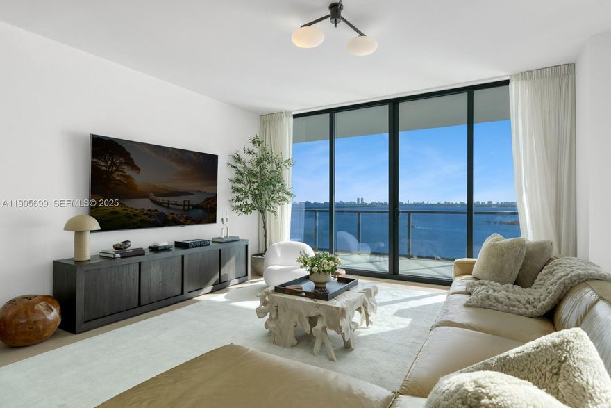 Elegantly curated 3-bed, 4.5-bath residence offering 2,743 sq ft of sophisticated living space at Elysee in Edgewater. Private elevator access ensures exclusivity and privacy. The home is bathed in natural light, showcasing panoramic views of Biscayne Bay, the ocean, and the city skyline from expansive terraces. The residence was meticulously upgraded to include elegant hardwood floors, custom drapery, designer light fixtures, and a fresh, modern paint palette. Elysee residents enjoy a luxurious lifestyle with amenities including a sky lounge, multiple pools, a fitness center and spa, and dedicated concierge services. Located minutes from the Design District and Miami Beach. Ability to convert to a 4-bedroom layout. Buyers may purchase furniture separately. 24 hours notice for showings.