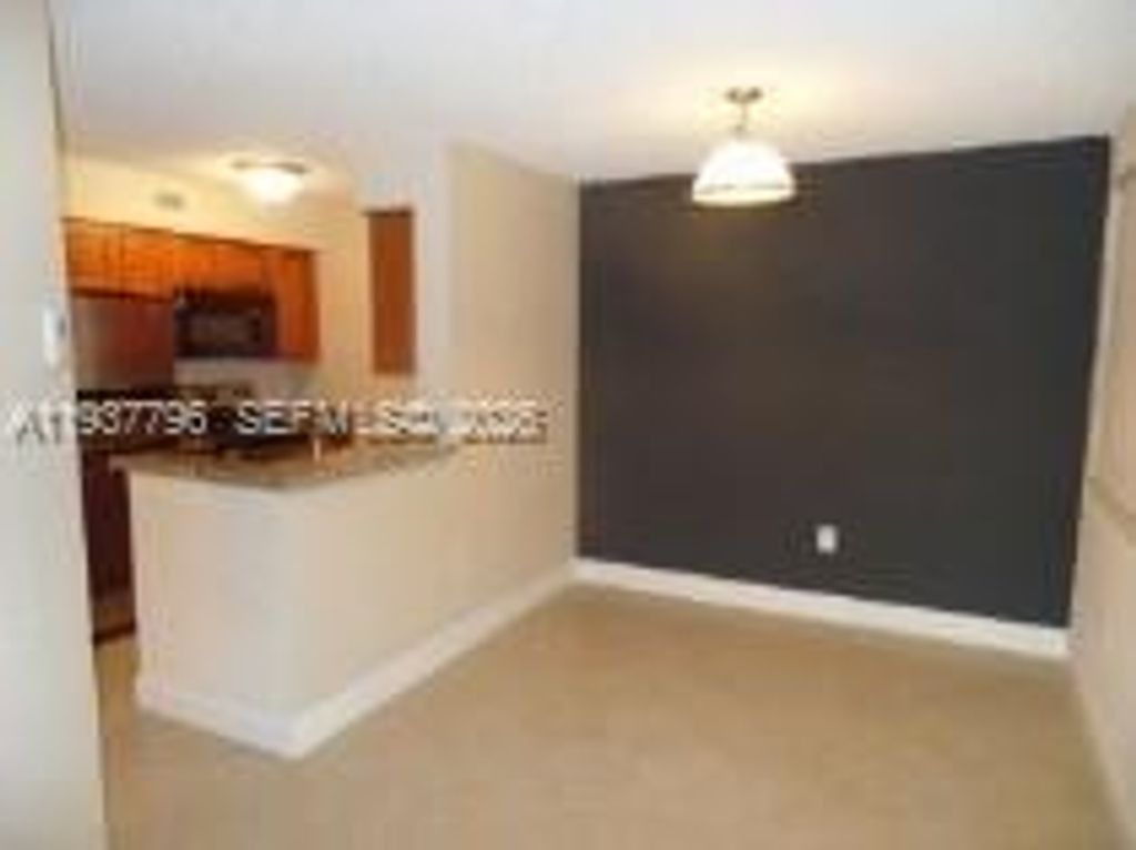 Photo of 2831 N Oakland Forest Dr #103, Oakland Park, FL 33309 (MLS # A11937796)