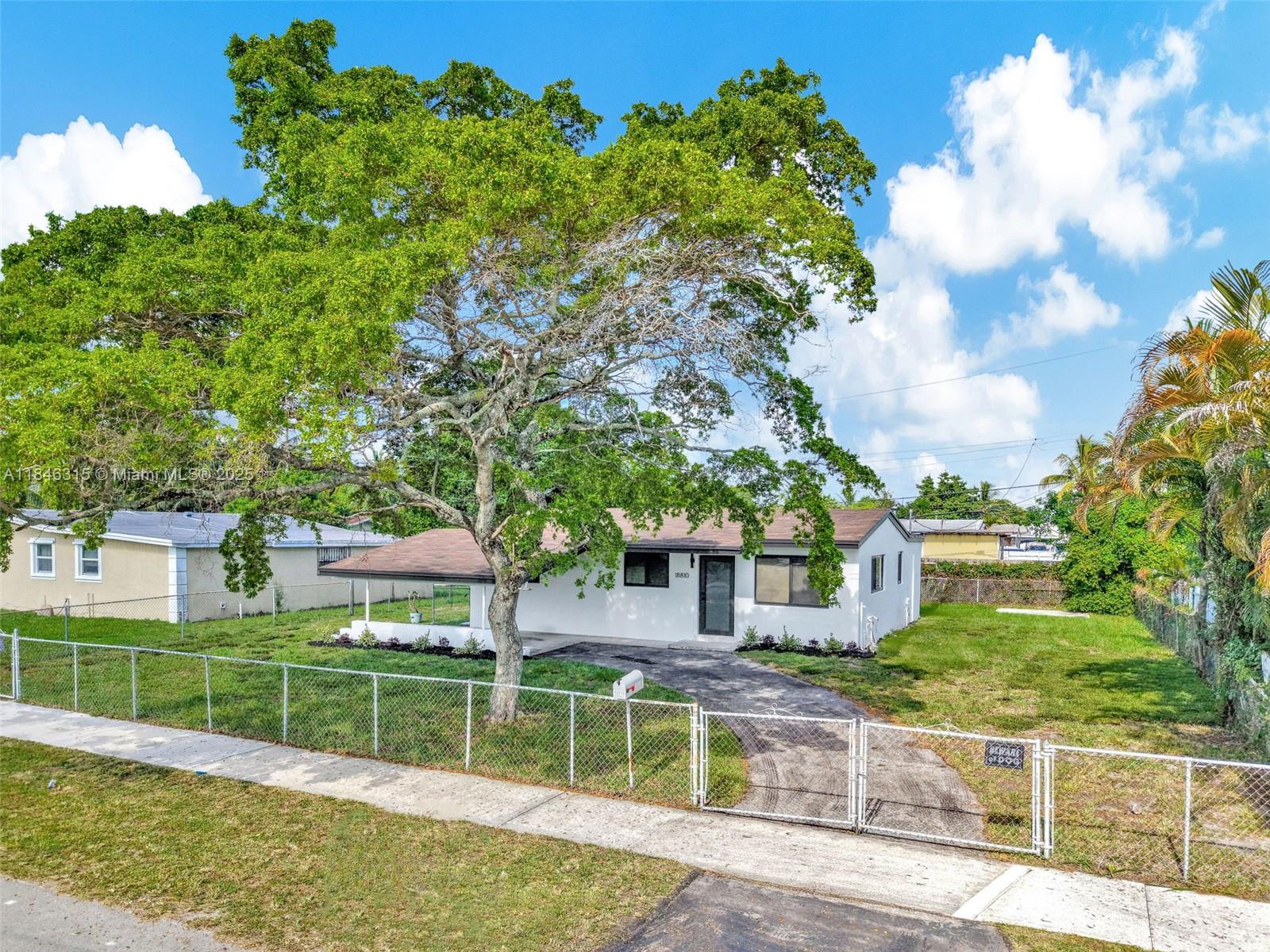 Ideal for families and first time home buyers this updated 3-bedroom, 2-bathroom home in Miami Gardens features a modern kitchen, renovated bathrooms, and recessed lighting throughout. Impact windows provide added safety, while fresh interior and exterior paint create a move-in-ready feel. Enjoy a spacious, fenced yard, new landscaping, and a carport for convenient parking. Perfect for families or first-time buyers looking for a well-maintained, turn-key home in a desirable neighborhood. Property is bigger than tax roll