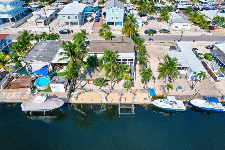 Seller Must Sell! Bring Your Boat and Start enjoying Keysliving at this Beautiful Bayside Home in Key Largo! 60 foot Concrete Dock with 10,000 lb Lift, completely Fenced in with Top of the Line Synthetic Grass and a Wonderful Tiki Hut for Outdoor Entertaining! Just Move in and bring your Clothes as this Home is fully furnished and Equipped to Enjoy right away or take over Monthly Rental Reservations. Less than an hour drive from Miami and Near all the best Restaurants and nearby Activities the Keys has to offer both on Land and by Water!